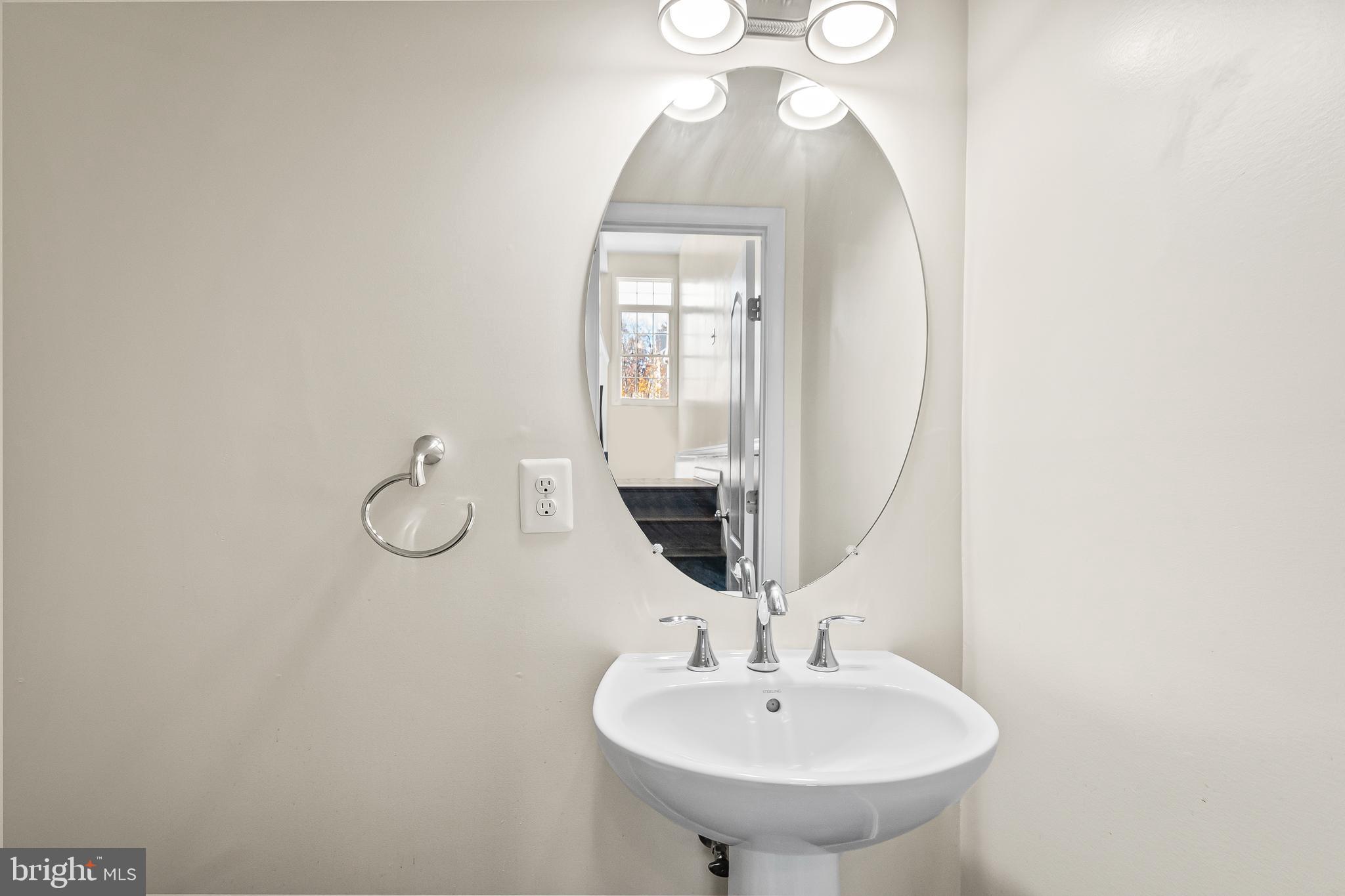 7872 Azalea Cove Terrace Alexandria, VA 22315 - Photo 14 of 30 a bathroom with a sink and a mirror