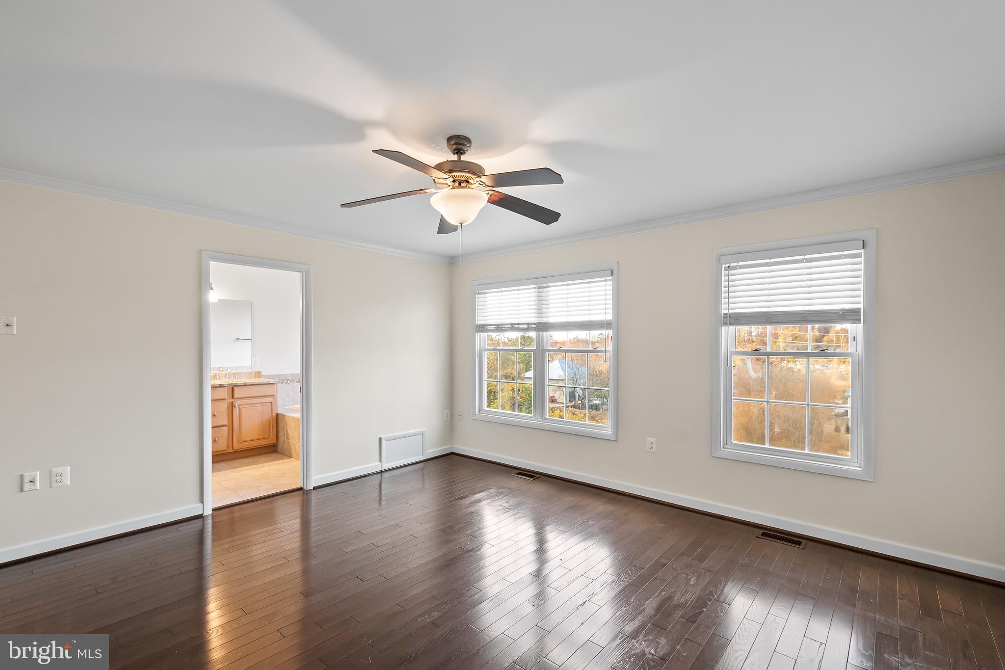7872 Azalea Cove Terrace Alexandria, VA 22315 - Photo 16 of 30 a view of an empty room with a window and wooden floor