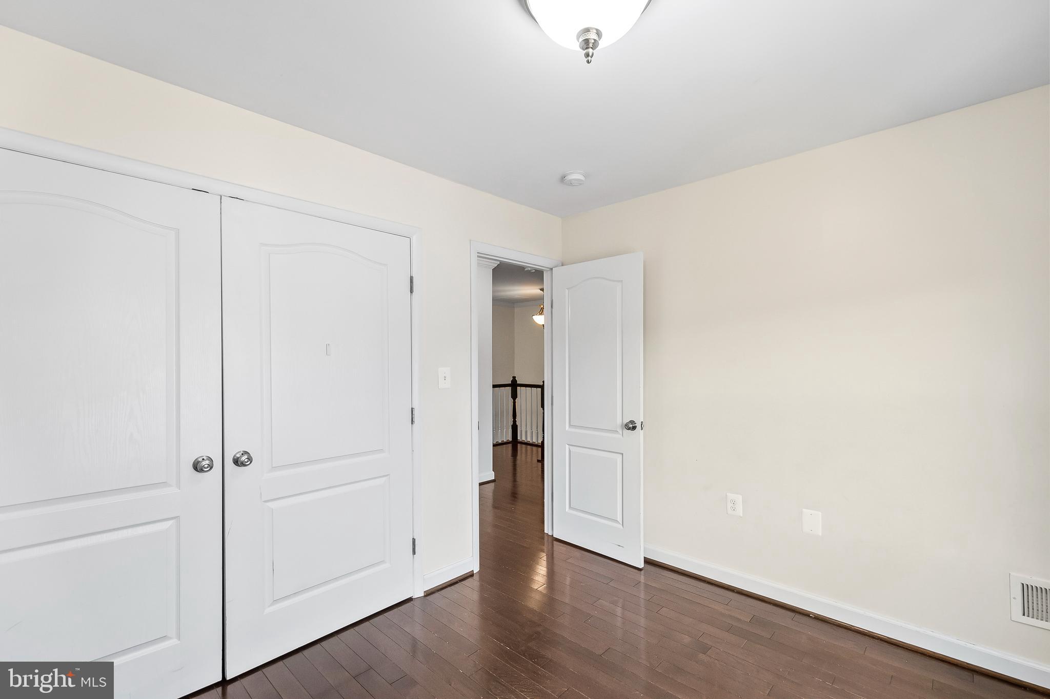 7872 Azalea Cove Terrace Alexandria, VA 22315 - Photo 23 of 30 an empty room with wooden floor