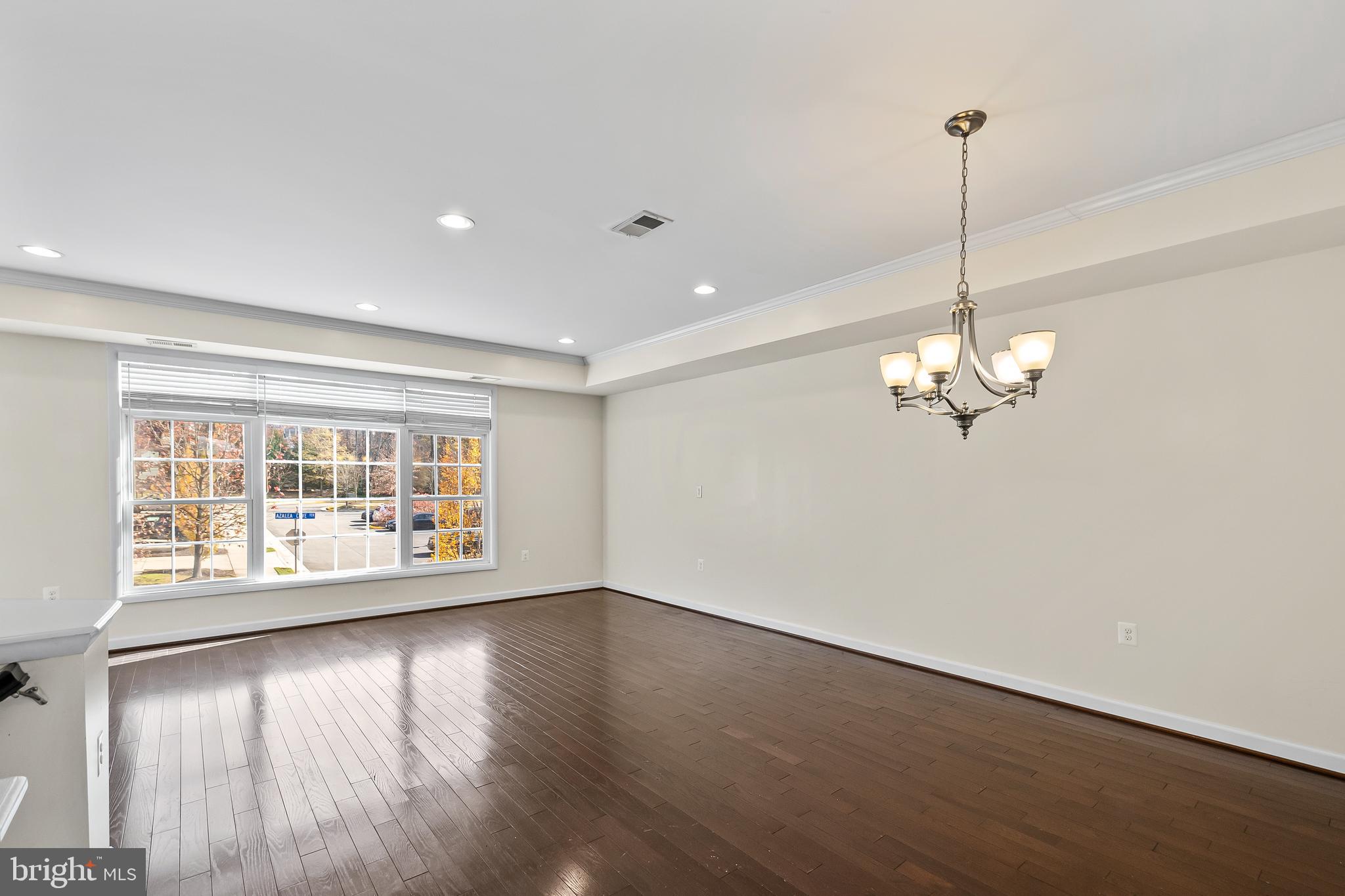 7872 Azalea Cove Terrace Alexandria, VA 22315 - Photo 5 of 30 a view of an empty room with wooden floor and a window