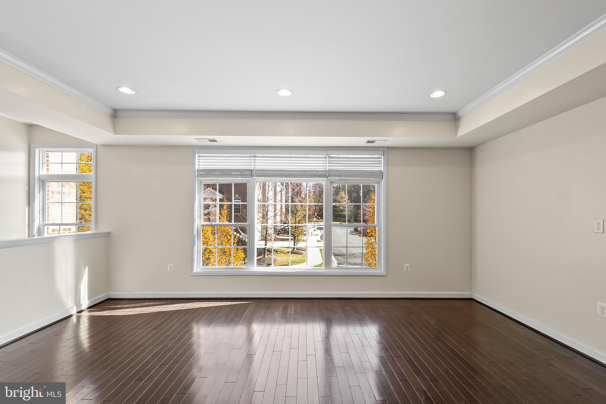 7872 Azalea Cove Terrace Alexandria, VA 22315 - Photo 6 of 30 an empty room with wooden floor and windows