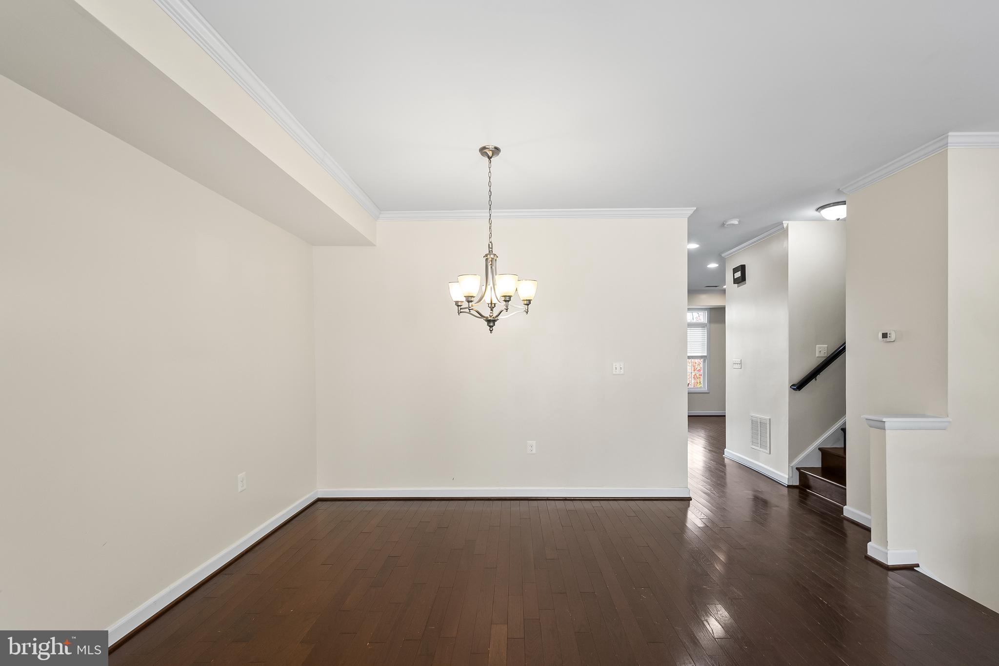 7872 Azalea Cove Terrace Alexandria, VA 22315 - Photo 8 of 30 a view of a livingroom with wooden floor and a ceiling fan