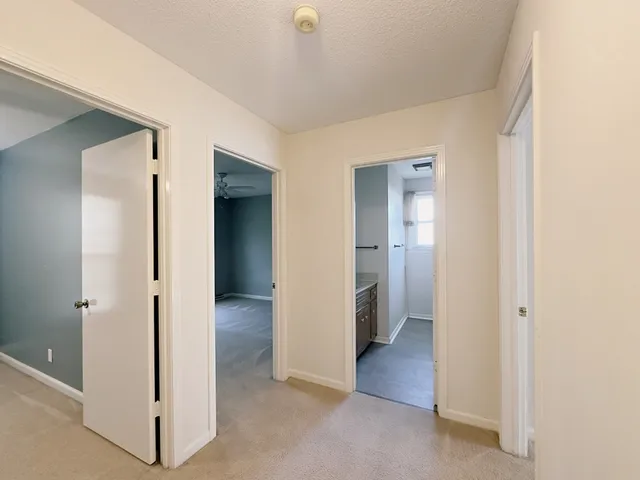 a view of a hallway with closet and wooden floor