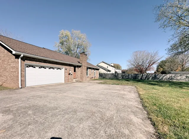 a view of a house with a yard and garage