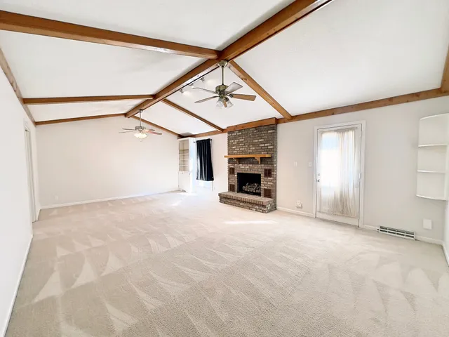 a view of empty room with fireplace