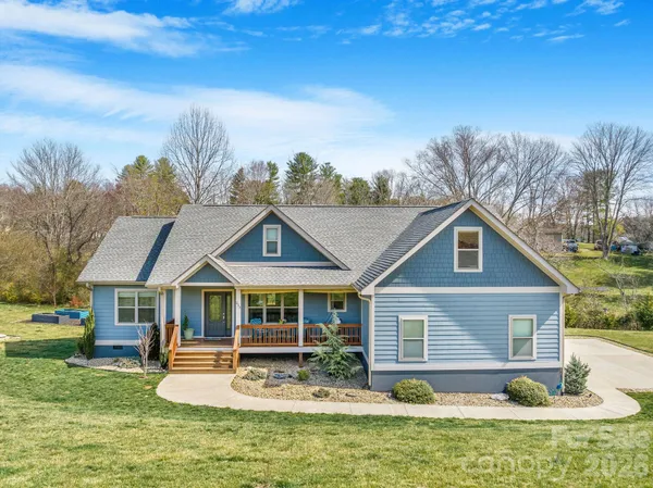 a front view of house with yard outdoor seating and barbeque oven
