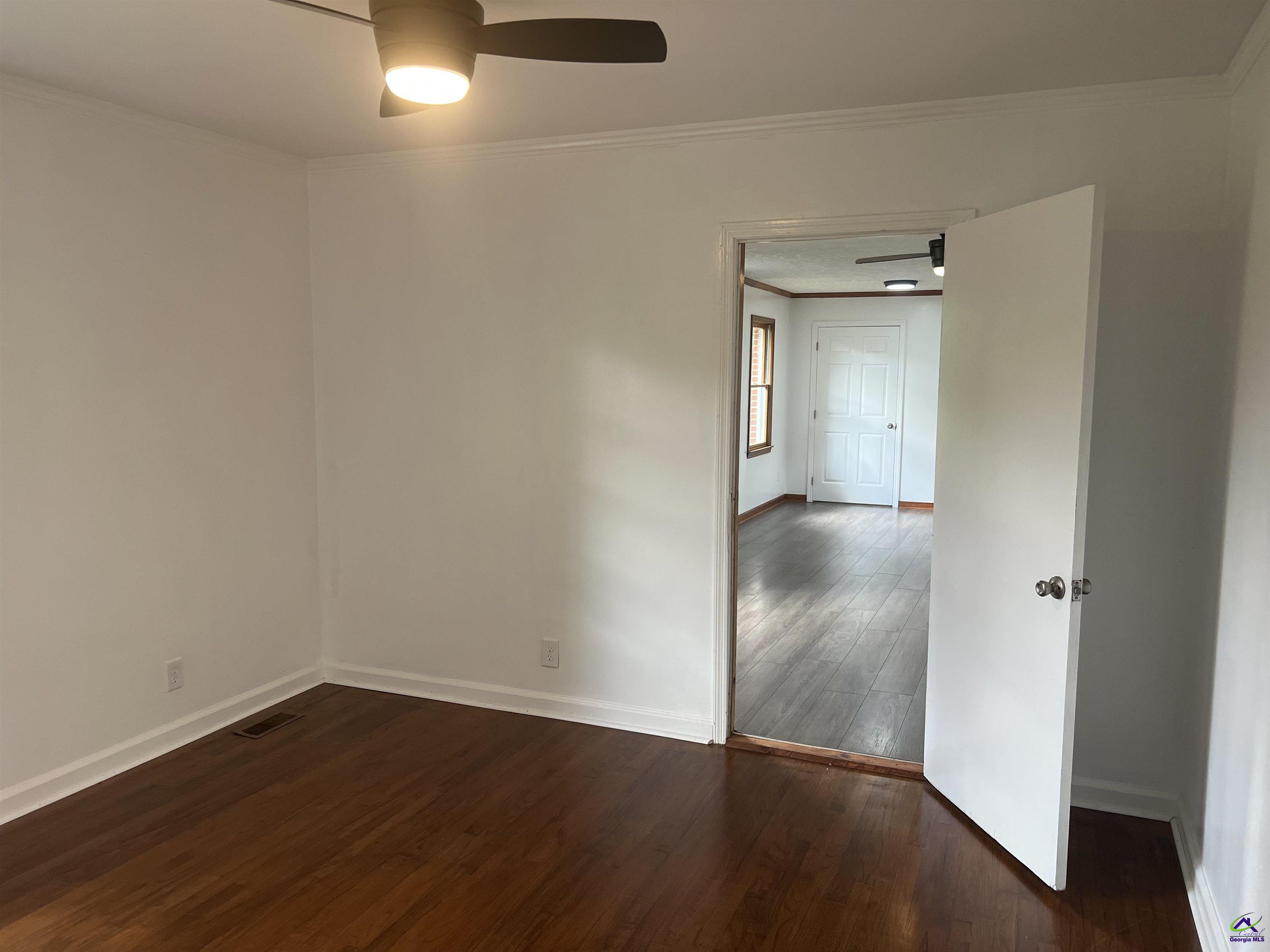 145 South 2nd Street Cochran, GA 31014 - Photo 20 of 24 a view of an empty room with wooden floor