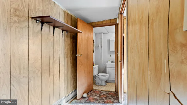 a bathroom with a toilet a sink and shower
