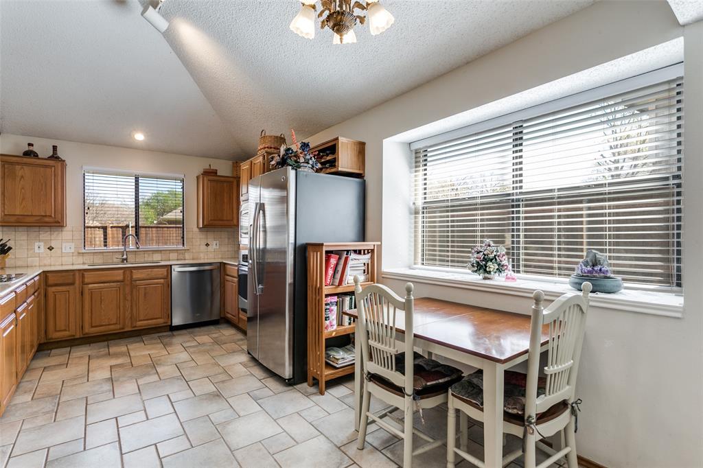 3414 Spring Willow Drive Grapevine, TX 76051 - Photo 11 of 25 a kitchen with stainless steel appliances granite countertop a stove a sink dishwasher and a refrigerator