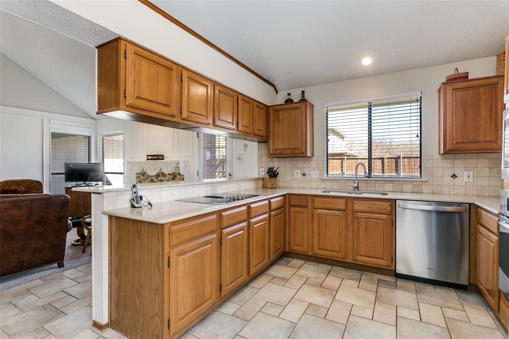 3414 Spring Willow Drive Grapevine, TX 76051 - Photo 12 of 25 a kitchen with a sink cabinets and window
