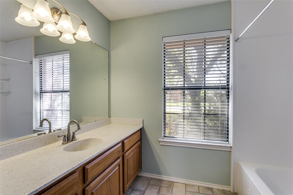 3414 Spring Willow Drive Grapevine, TX 76051 - Photo 14 of 25 a bathroom with a sink a vanity and a large mirror