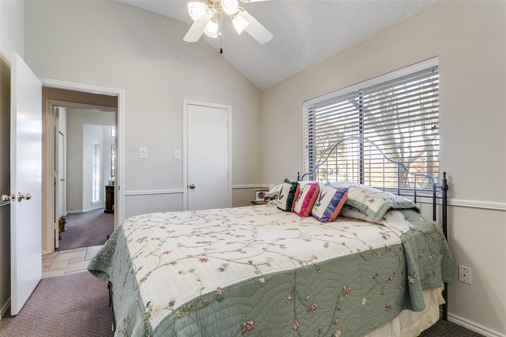 3414 Spring Willow Drive Grapevine, TX 76051 - Photo 15 of 25 a bedroom with a large bed and a chandelier