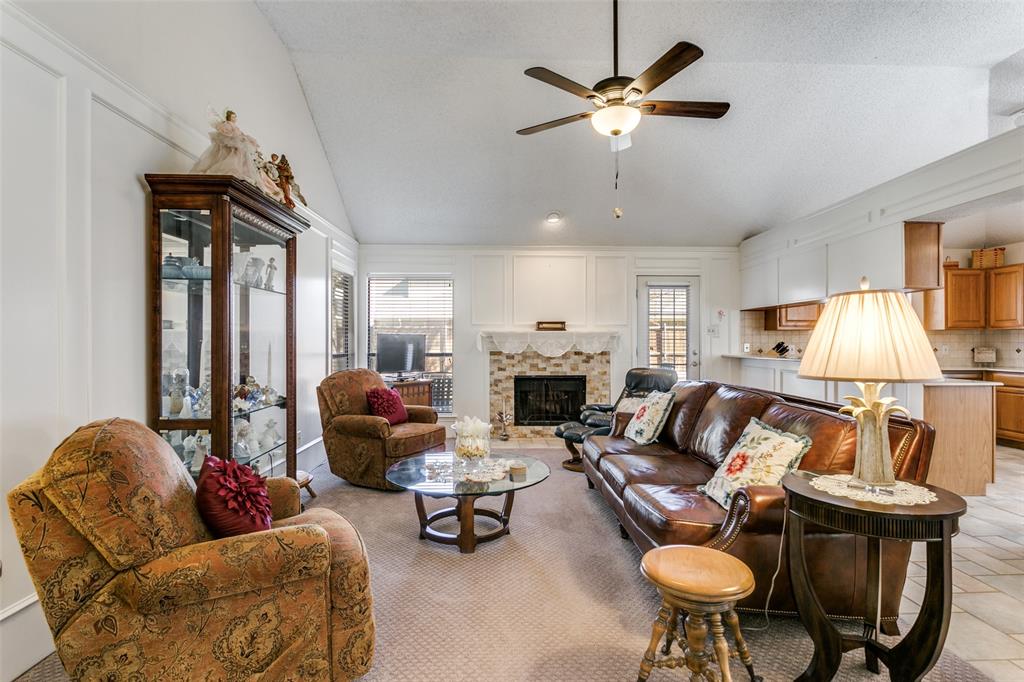 3414 Spring Willow Drive Grapevine, TX 76051 - Photo 5 of 25 a living room with furniture a fireplace and a chandelier
