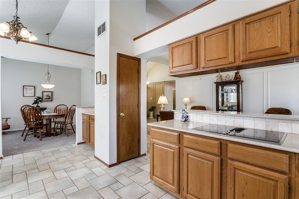 3414 Spring Willow Drive Grapevine, TX 76051 - Photo 9 of 25 a kitchen with stainless steel appliances granite countertop a refrigerator and cabinets