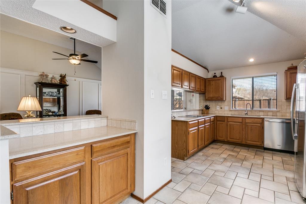 3414 Spring Willow Drive Grapevine, TX 76051 - Photo 10 of 25 a kitchen with a sink cabinets and stainless steel appliances