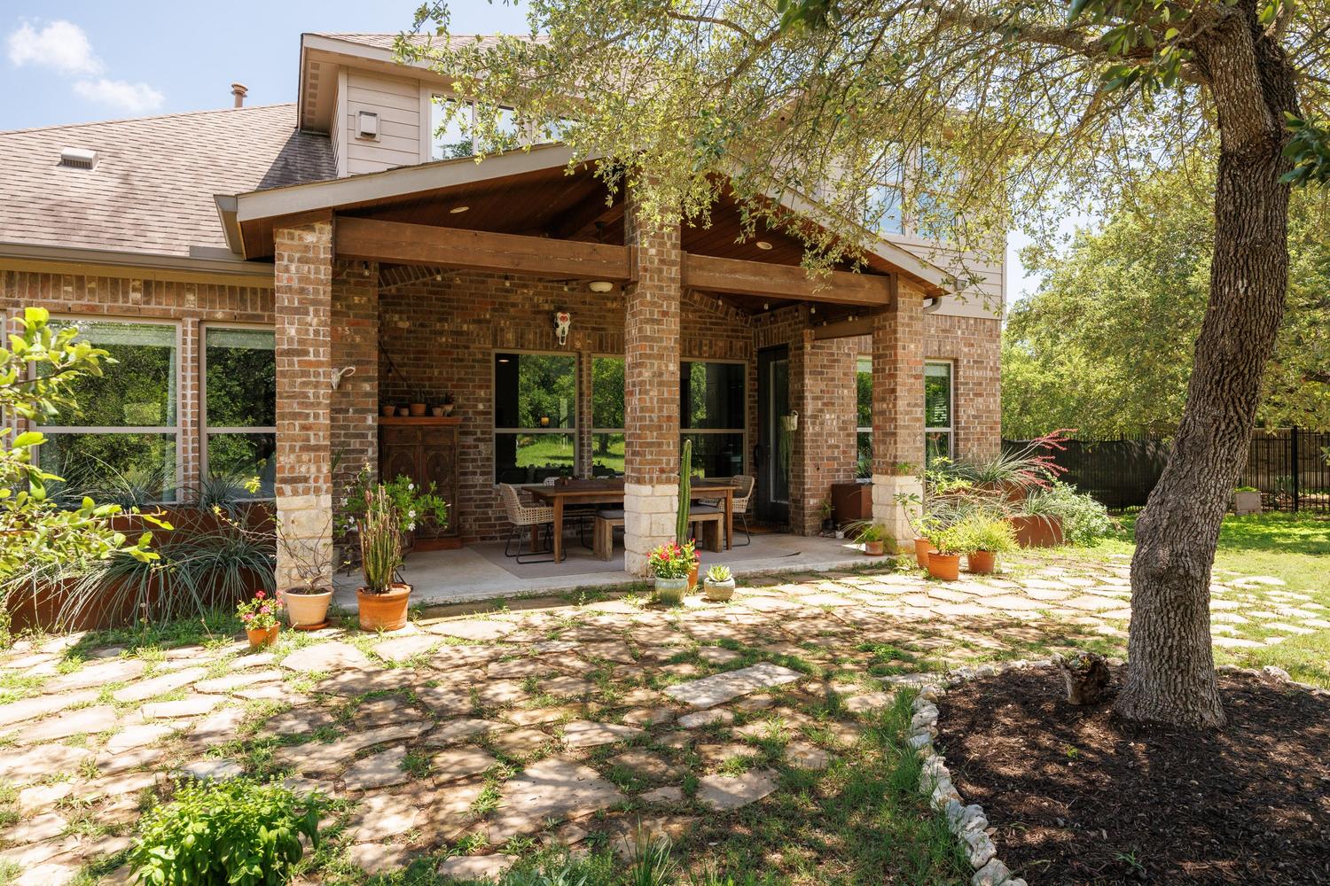 1135 Blue Ridge Drive Dripping Springs, TX 78620 - Photo 30 of 36 A spacious covered patio offers an ideal setting for outdoor dining and relaxation.