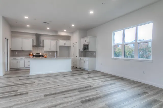 a view of kitchen with wooden floor and window