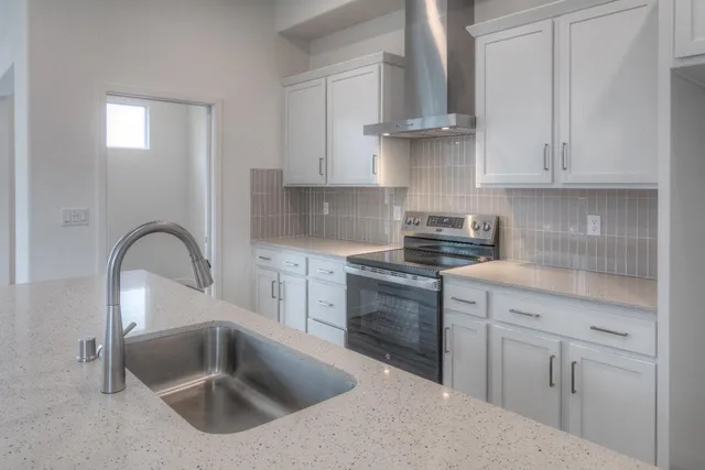 a kitchen with white cabinets and a sink