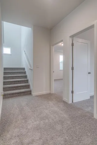 a view of an empty room with stairs and ventilation