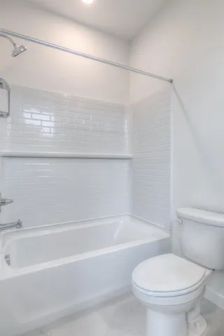 a bathroom with a toilet and a bathtub