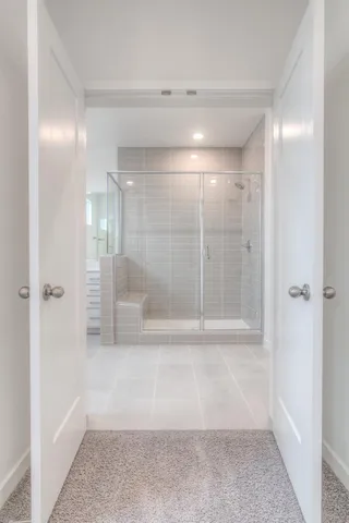 a bathroom with a glass shower door
