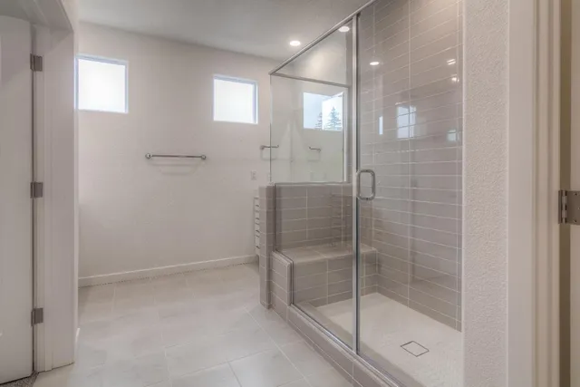 a bathroom with a glass shower door