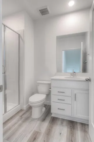a bathroom with a toilet sink and a mirror