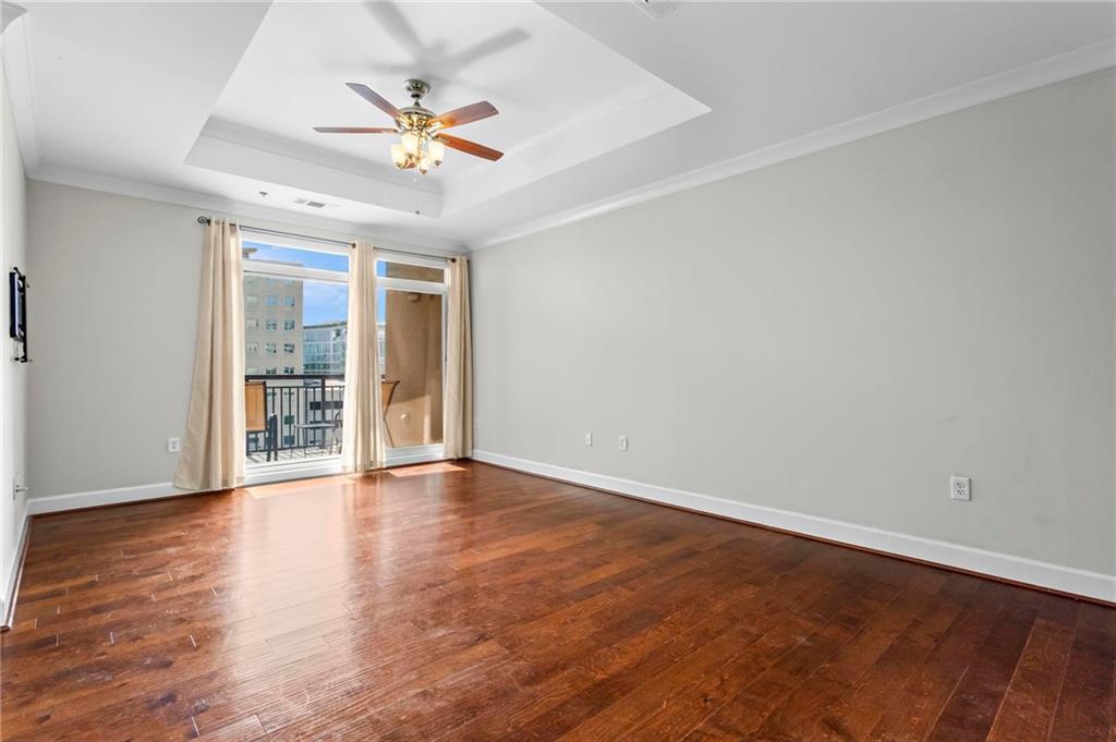325 East Paces Ferry Road Northeast, Unit 703 Atlanta, GA 30305 - Photo 15 of 31 wooden floor in an empty room with a window