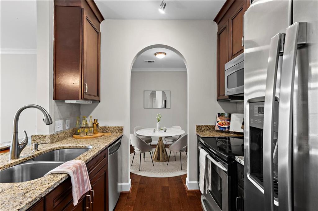 325 East Paces Ferry Road Northeast, Unit 703 Atlanta, GA 30305 - Photo 5 of 31 a kitchen with stainless steel appliances granite countertop a sink stove and refrigerator