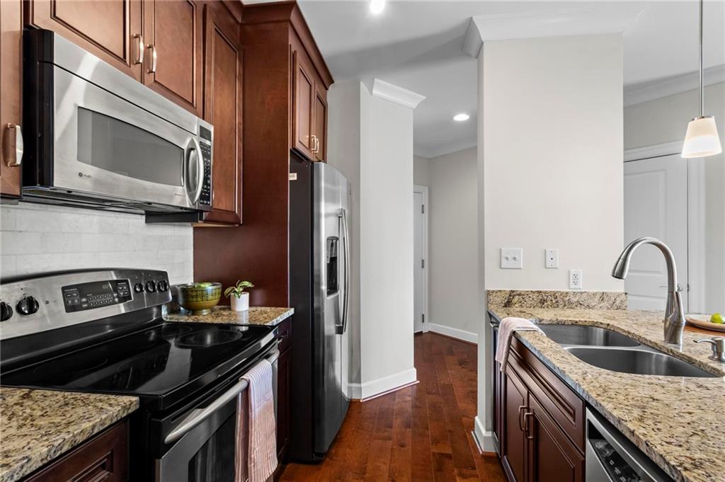 325 East Paces Ferry Road Northeast, Unit 703 Atlanta, GA 30305 - Photo 7 of 31 a kitchen with a stove microwave and sink