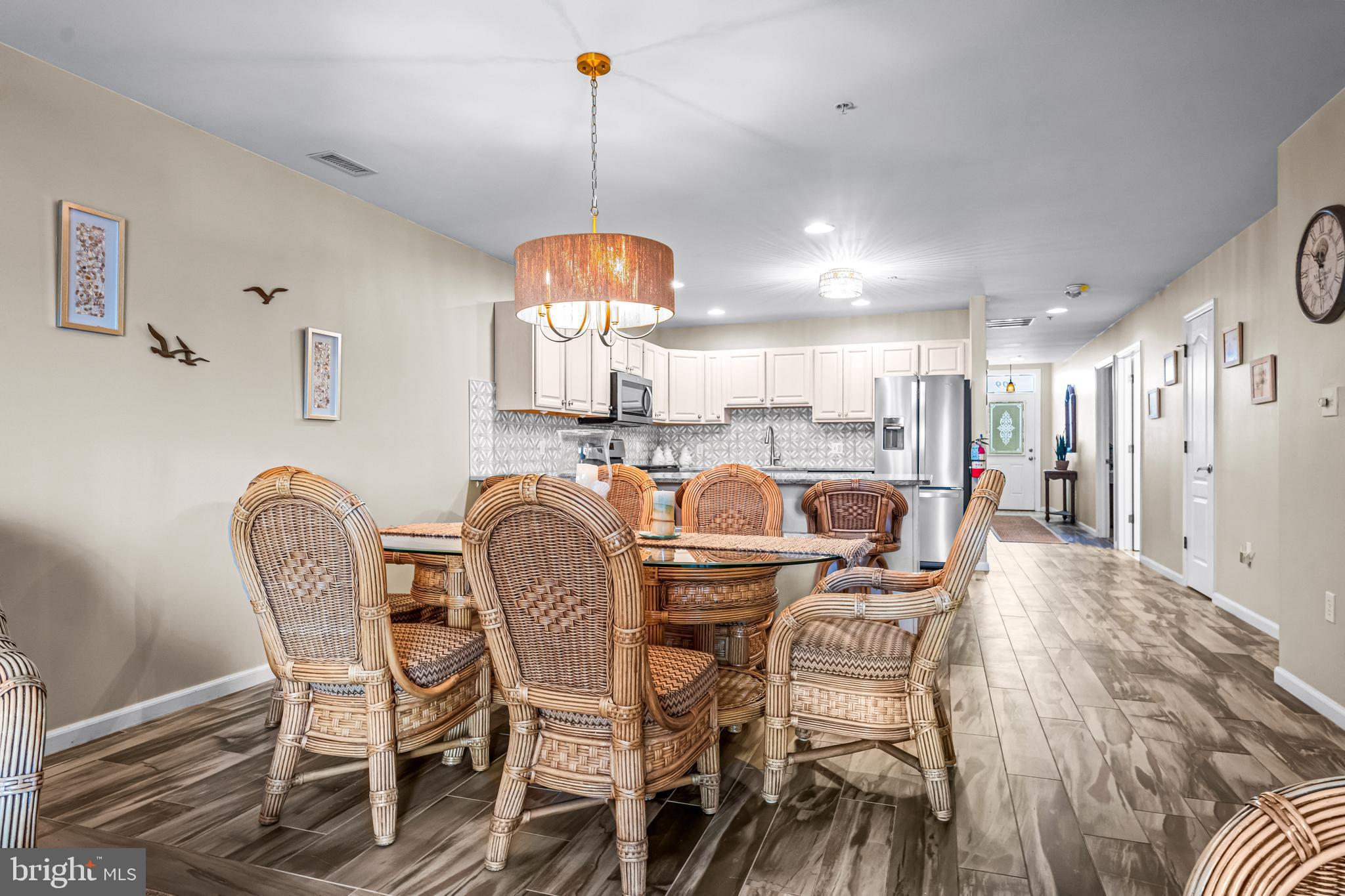 301 East Rochester Avenue, Unit 409 Wildwood, NJ 08260 - Photo 11 of 31 a dining room with furniture a chandelier and wooden floor