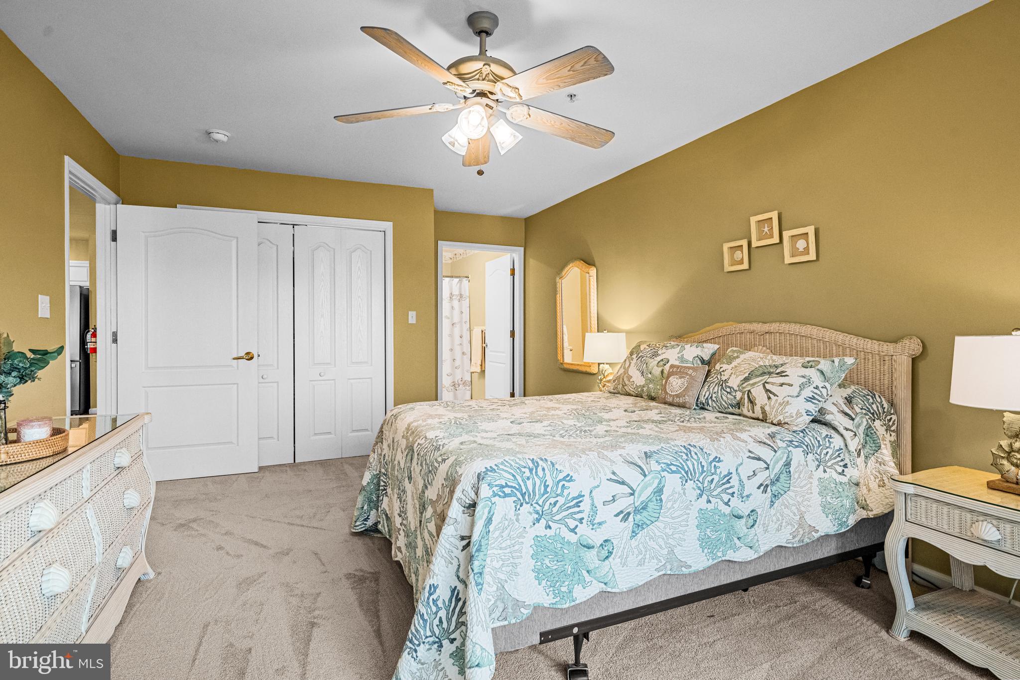 301 East Rochester Avenue, Unit 409 Wildwood, NJ 08260 - Photo 21 of 31 a bedroom with a bed and a chandelier