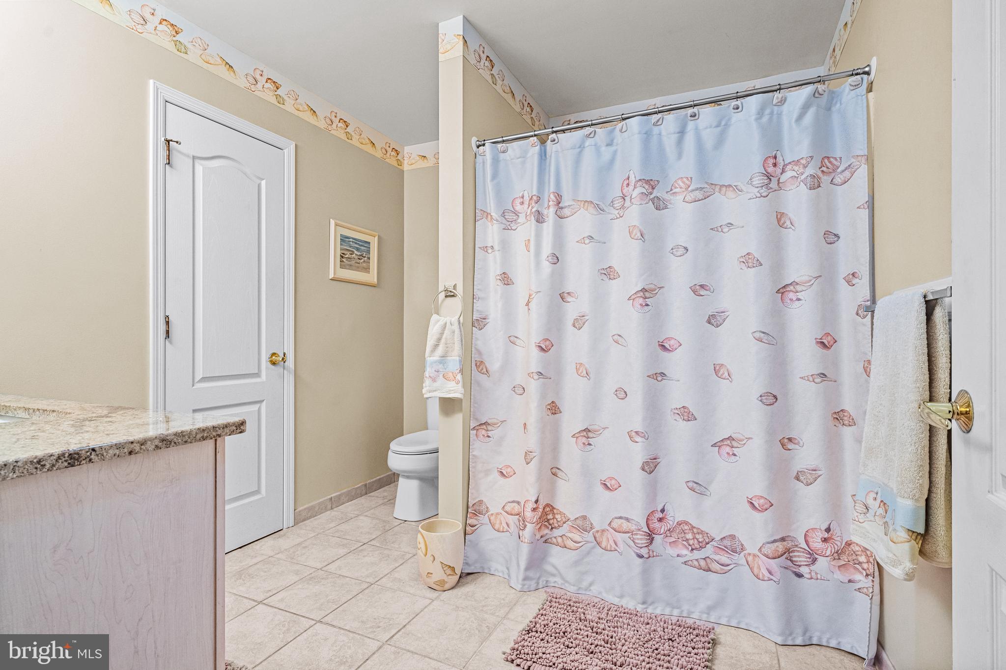 301 East Rochester Avenue, Unit 409 Wildwood, NJ 08260 - Photo 22 of 31 a bathroom with a sink toilet and shower