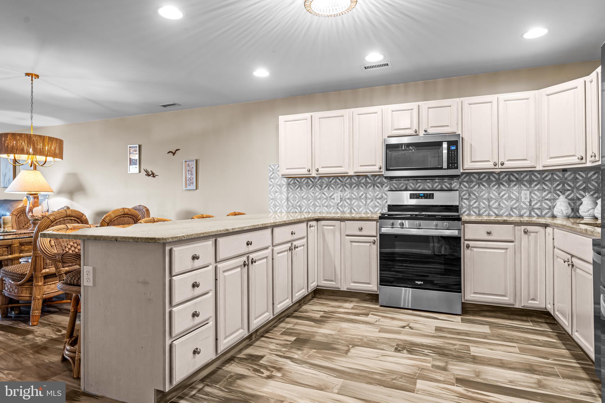 301 East Rochester Avenue, Unit 409 Wildwood, NJ 08260 - Photo 7 of 31 a kitchen with stainless steel appliances a stove sink microwave and cabinets