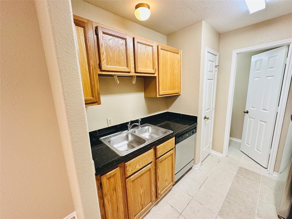 8814 Schick Road, Unit D Austin, TX 78729 - Photo 10 of 26 a kitchen with a stove and a refrigerator
