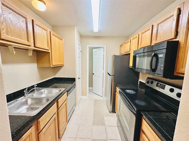 a kitchen with a stove and a refrigerator