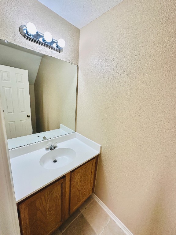 8814 Schick Road, Unit D Austin, TX 78729 - Photo 13 of 26 a bathroom with a sink and a mirror