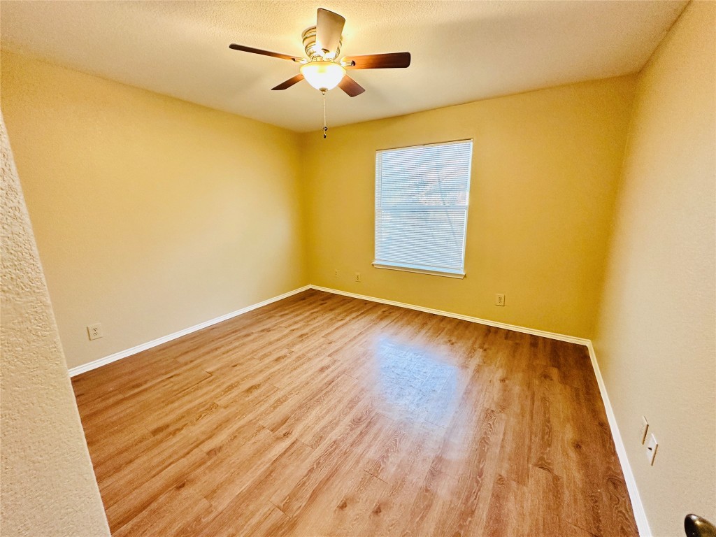 8814 Schick Road, Unit D Austin, TX 78729 - Photo 21 of 26 a view of room with wooden floor and ceiling fan