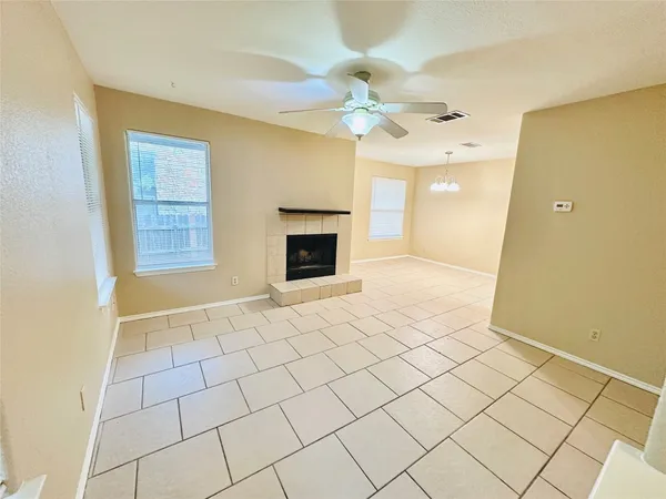 a view of an empty room with a fireplace