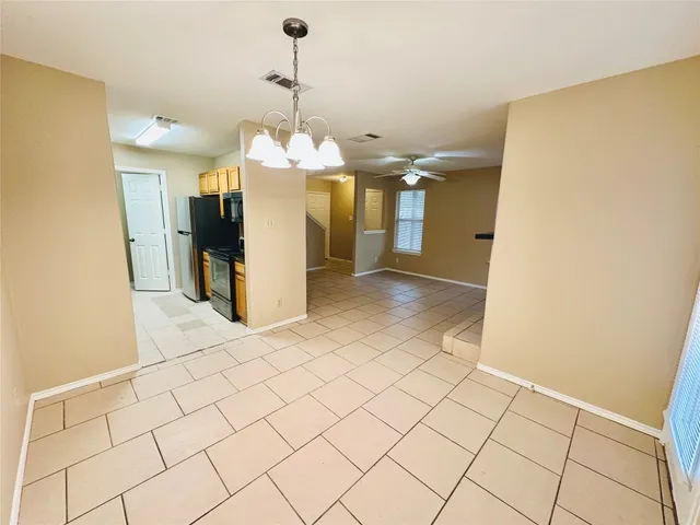 a white toilet sitting next to a bath tub