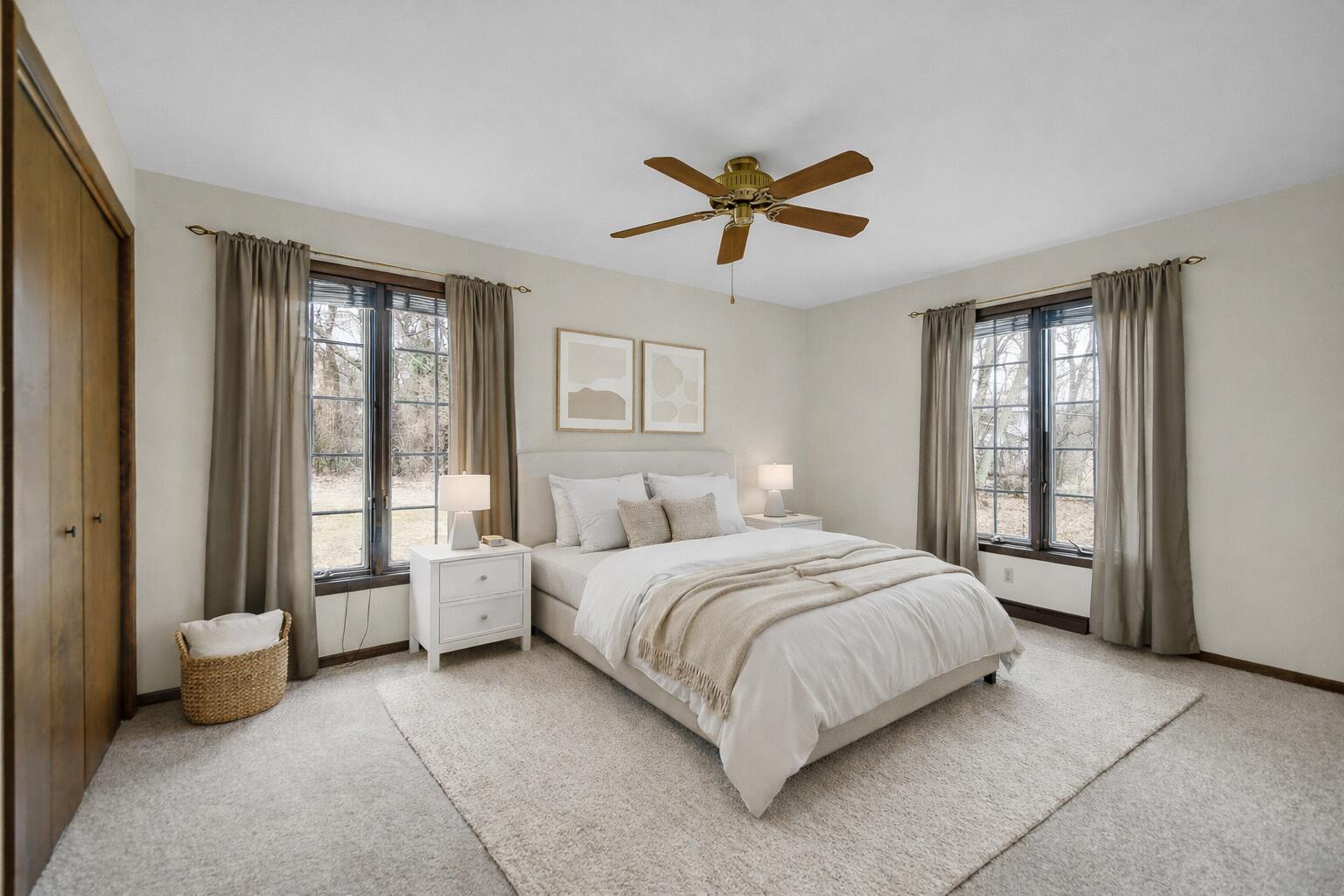 6955 Briergate Court Demotte, IN 46310 - Photo 19 of 44 a bedroom with a large bed and a chandelier