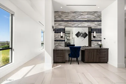 a kitchen with stainless steel appliances kitchen island granite countertop a refrigerator a stove a microwave oven a sink with a dining table and chairs