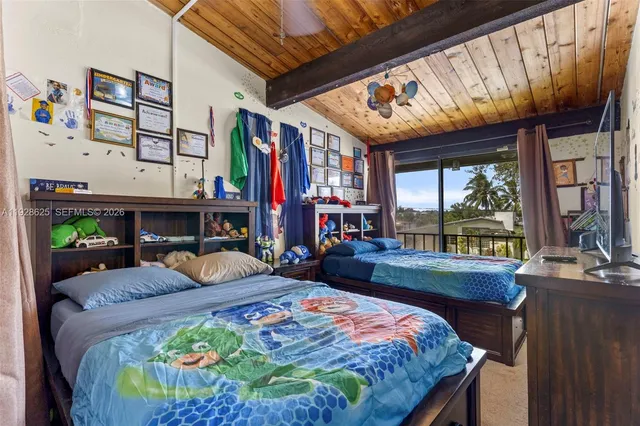 a bedroom with furniture and a flat screen tv