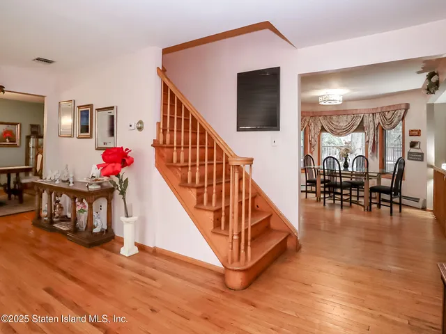 a view of entryway and hall with wooden floor