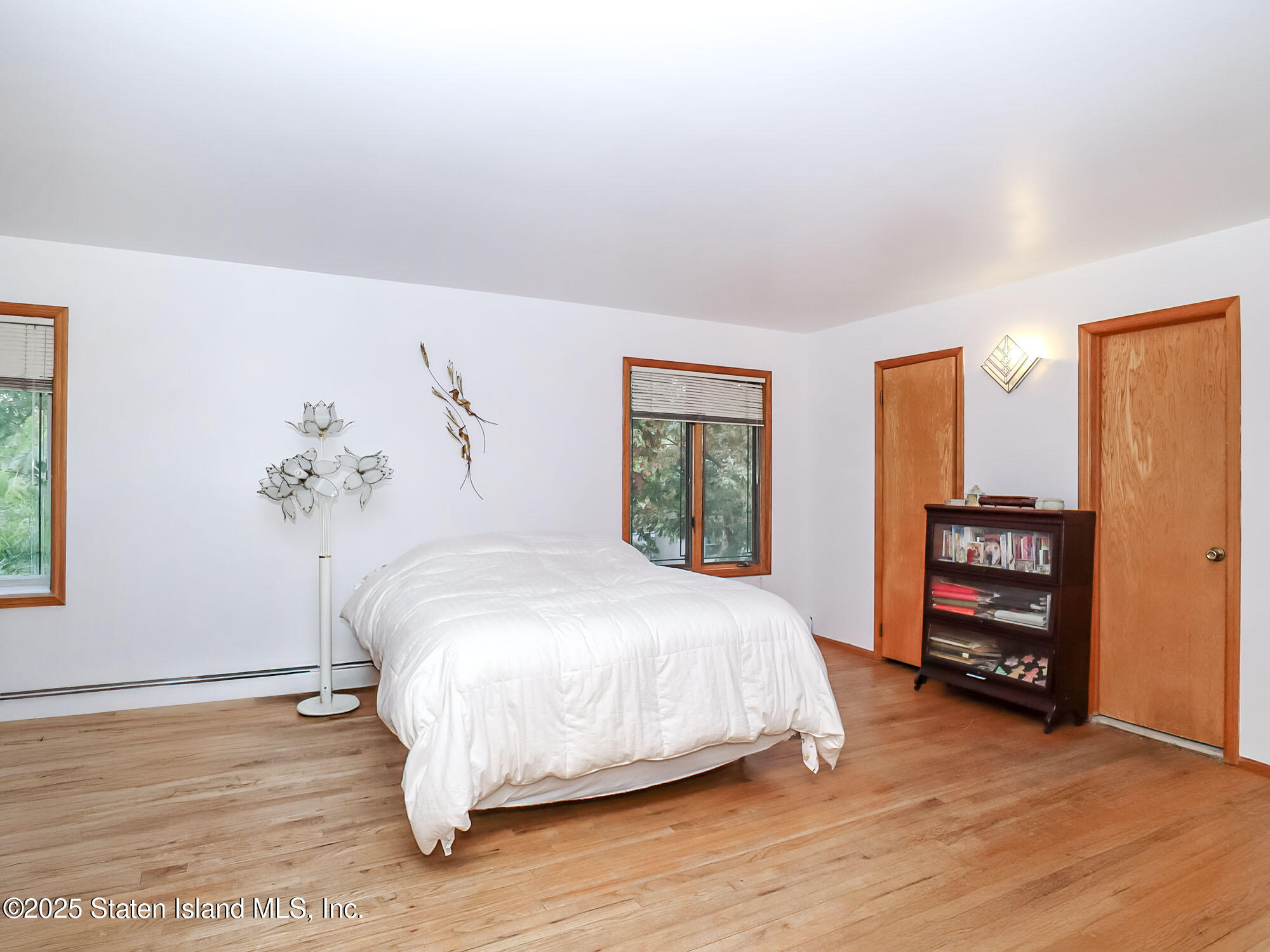282 Boscombe Avenue Staten Island, NY 10309 - Photo 14 of 34 a bedroom with a bed and wooden floor