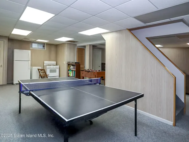 a room with pool table and windows