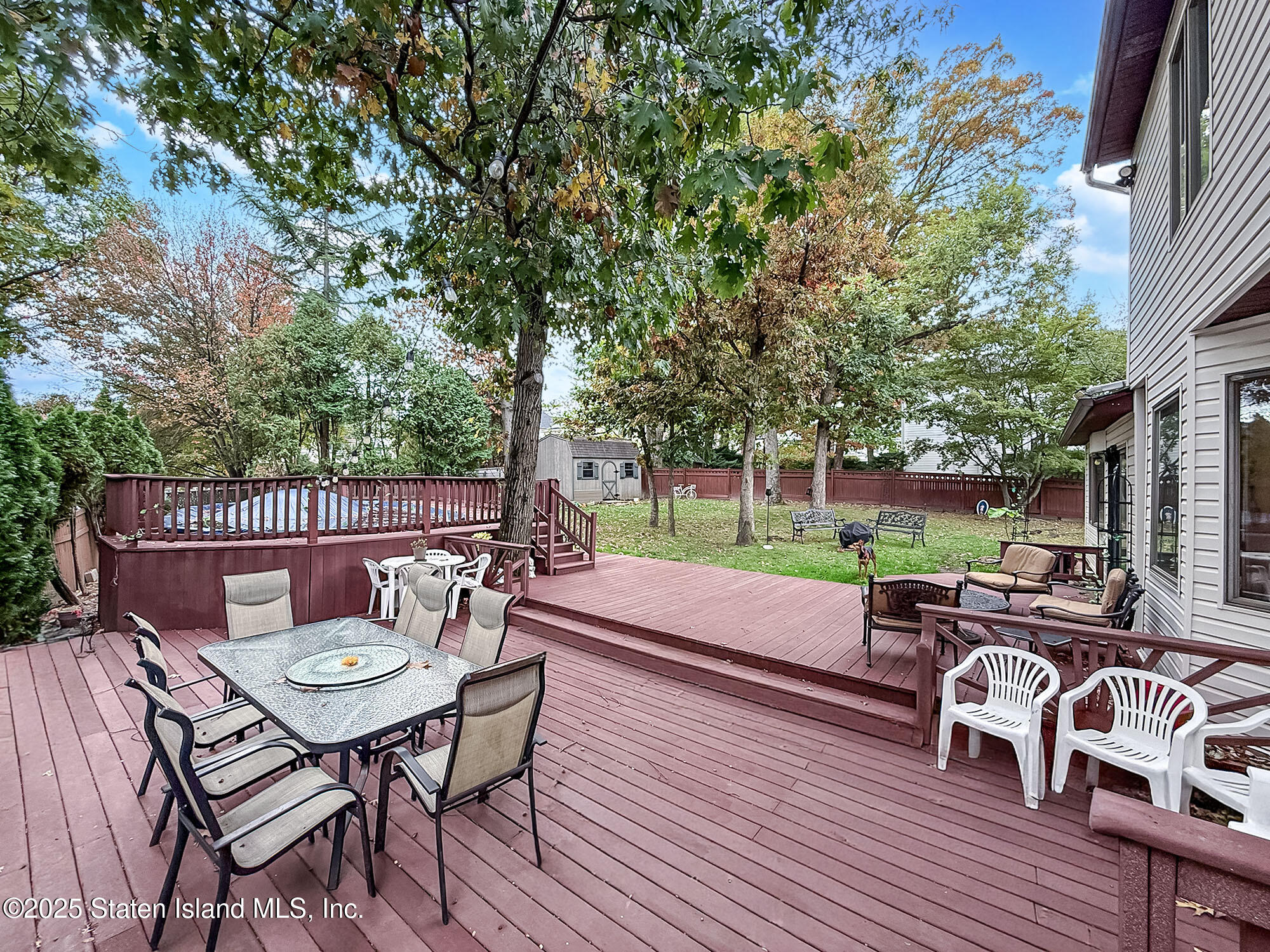 282 Boscombe Avenue Staten Island, NY 10309 - Photo 29 of 34 a view of a chairs and table in patio with a yard