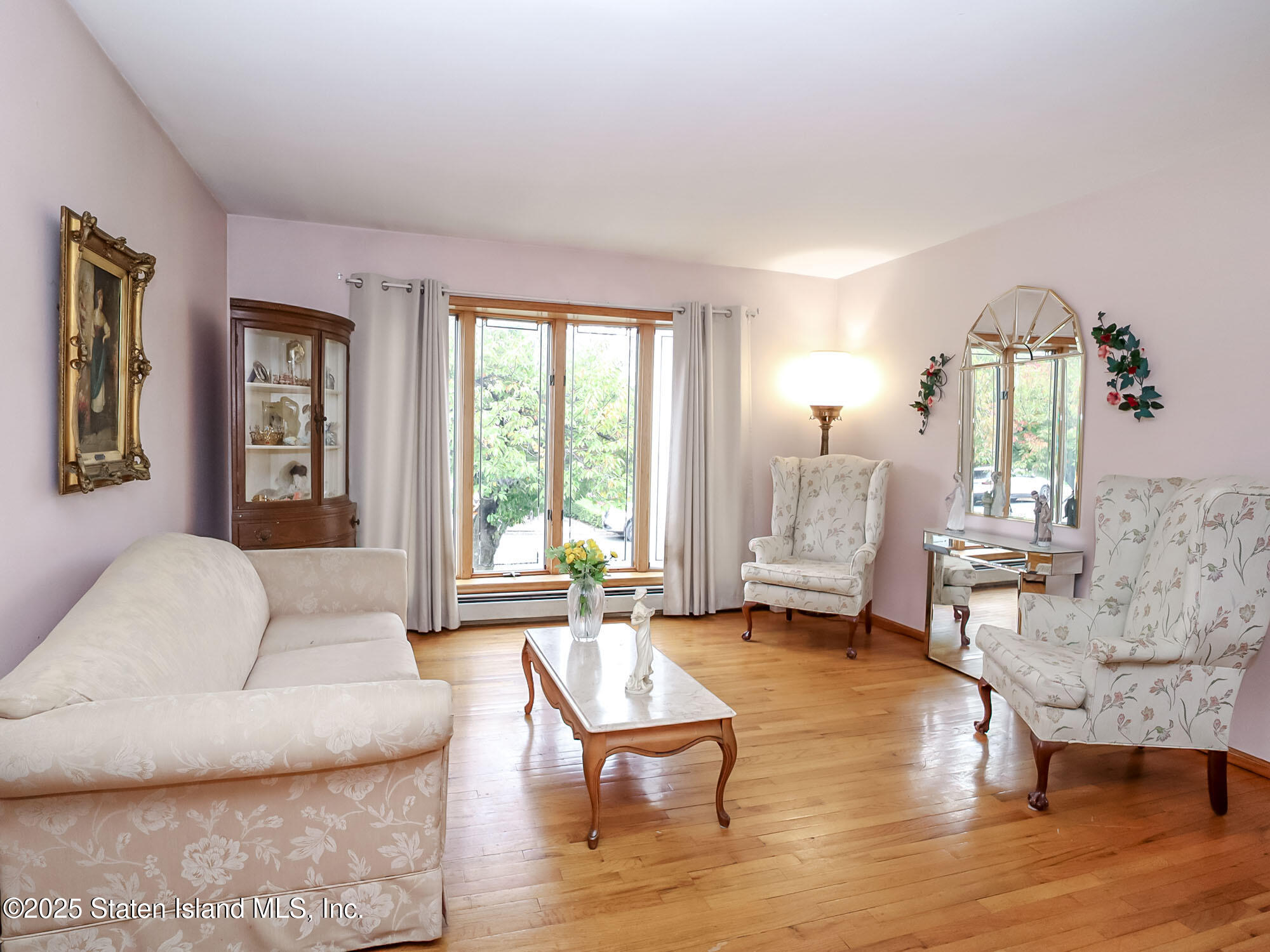 282 Boscombe Avenue Staten Island, NY 10309 - Photo 3 of 34 a living room with furniture and wooden floor