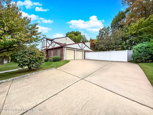 a view of a white house with a yard