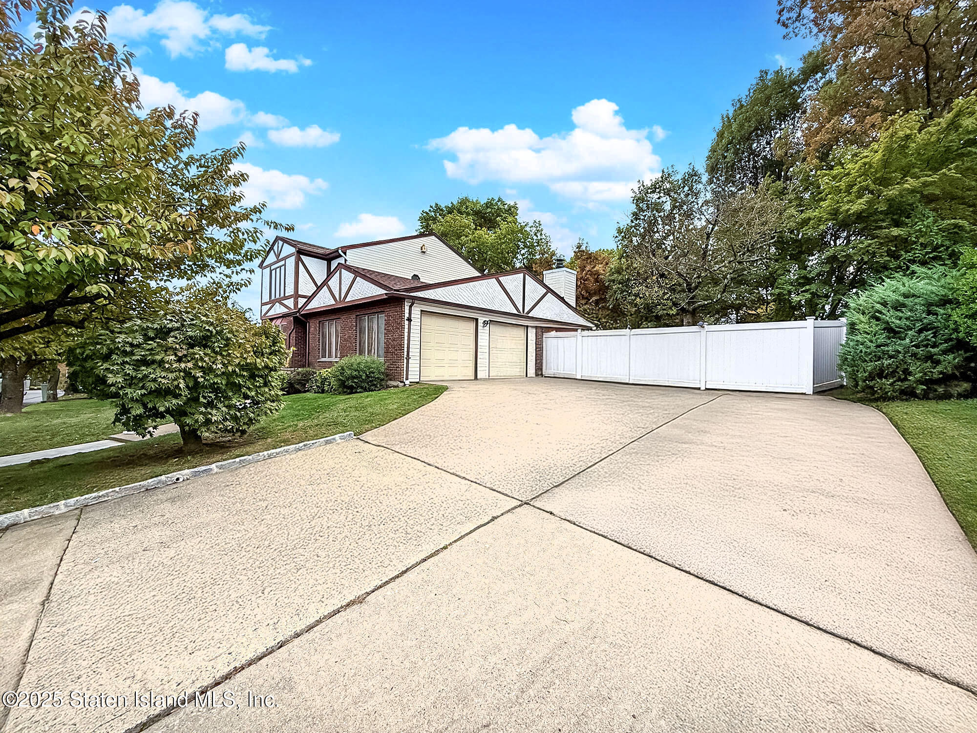282 Boscombe Avenue Staten Island, NY 10309 - Photo 31 of 34 a view of a white house with a yard